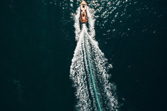 hfc-ban motor boat cutting through water and causing a wake